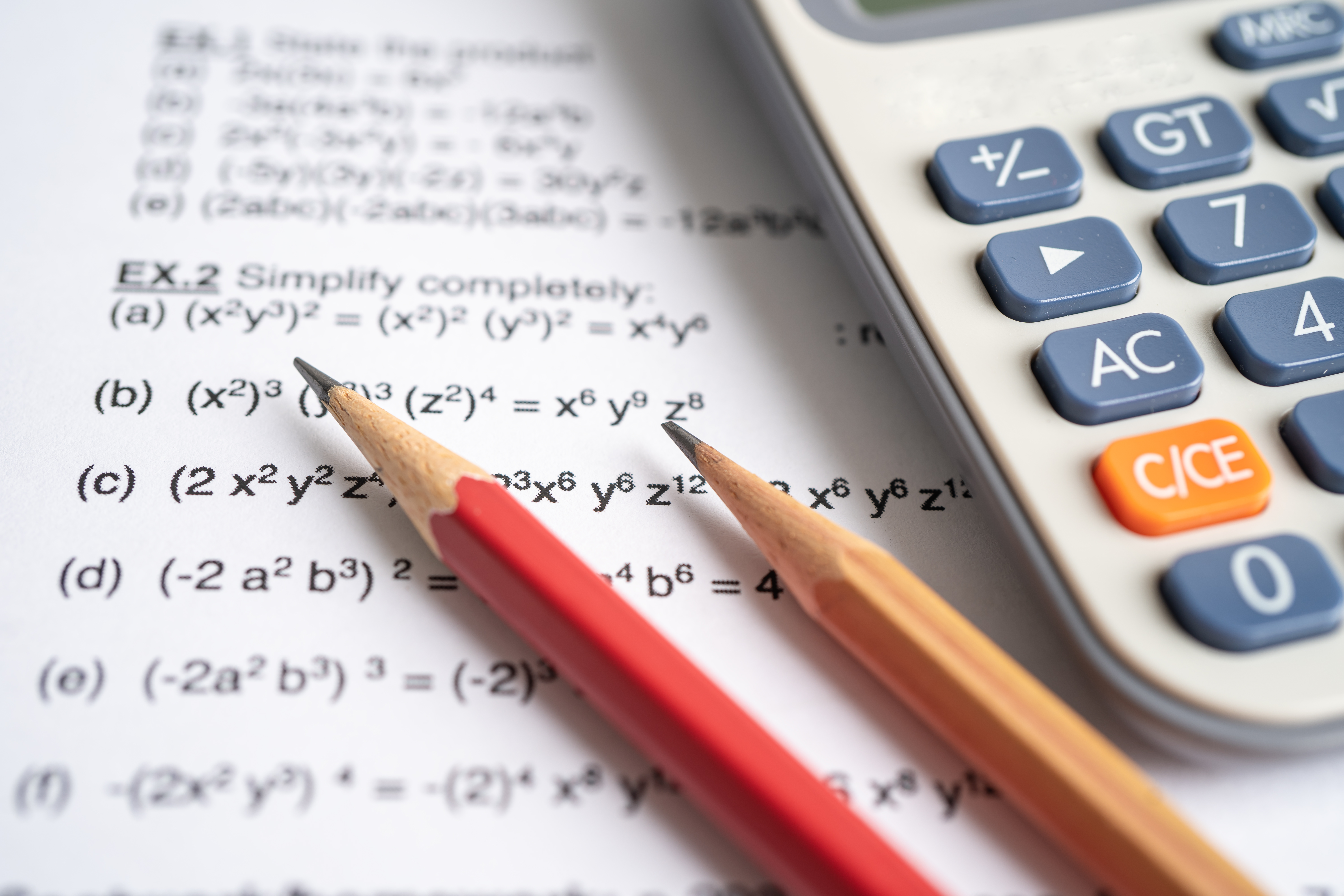 Pencil and calculator on mathematic formula exercise test paper Pencil and calculator on mathematic formula exercise test paper in education school.